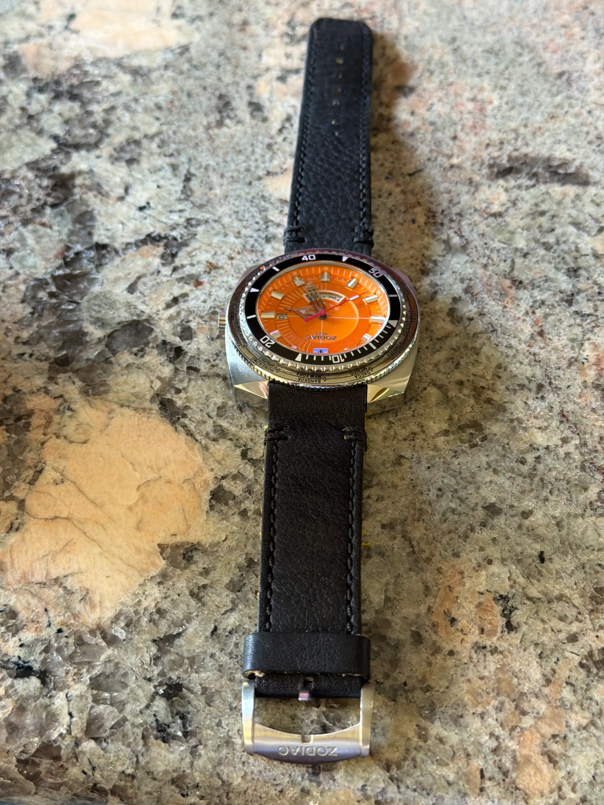 Zodiac Super SeaDragon GMT dual-time world timer, orange dial with black coin-edge bezel, straight-on